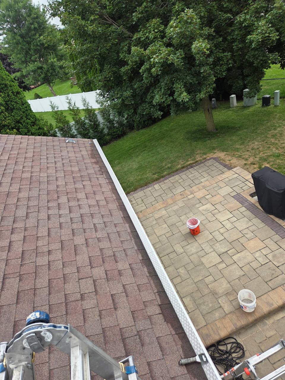 Finished gutter guard installation seen from the patio